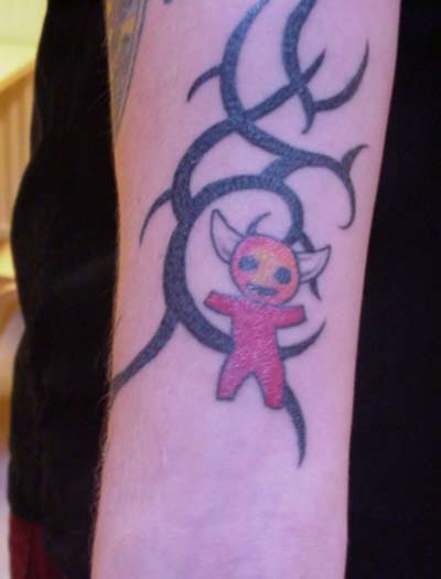 doll tattoo. devil doll in to the skin or